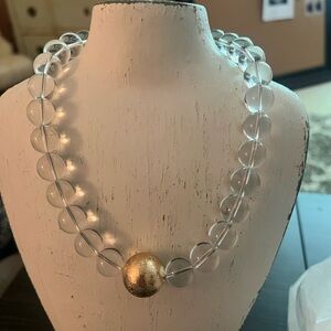 Lucite necklace with gold ball.   Adjustable in clasp.